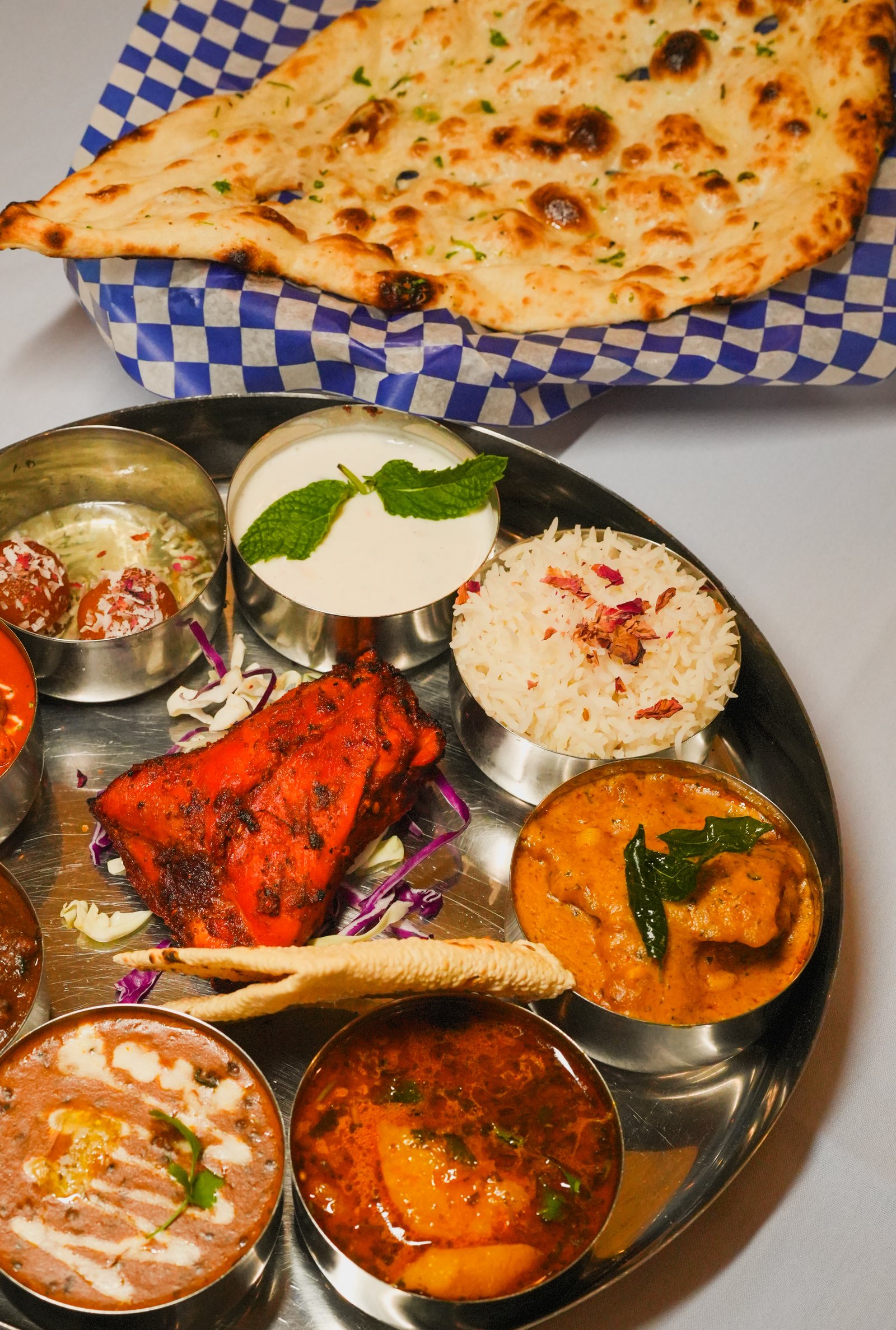 A Basant Indian thali with rice, dal, paneer and fresh naan
