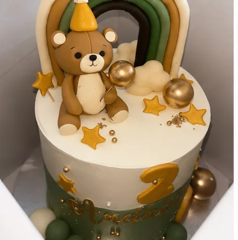 A custom teddy bear and rainbow birthday cake